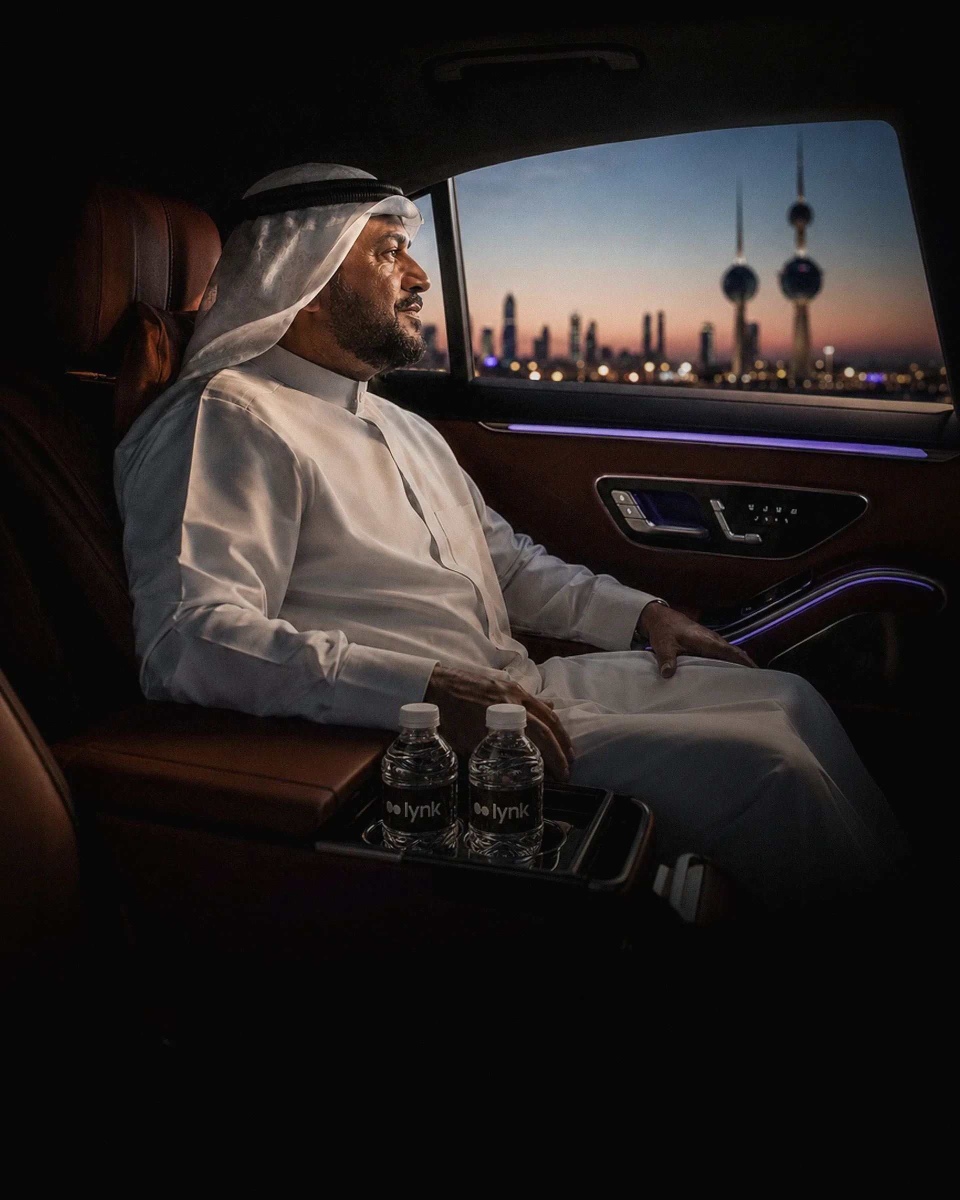 A passenger relaxing inside a Lynk vehicle overlooking Kuwait